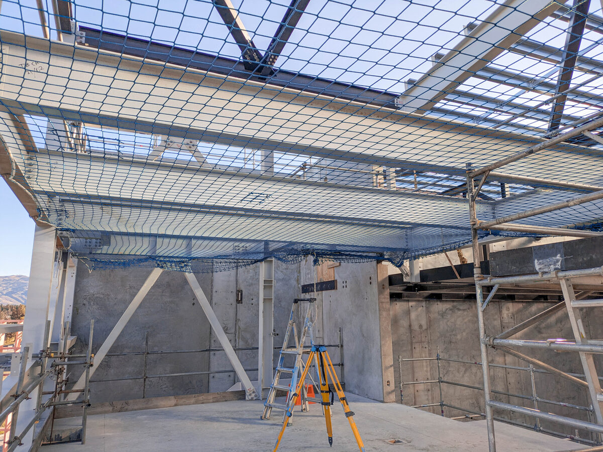 Fall arrest safety net coverage over a commercial construction work area